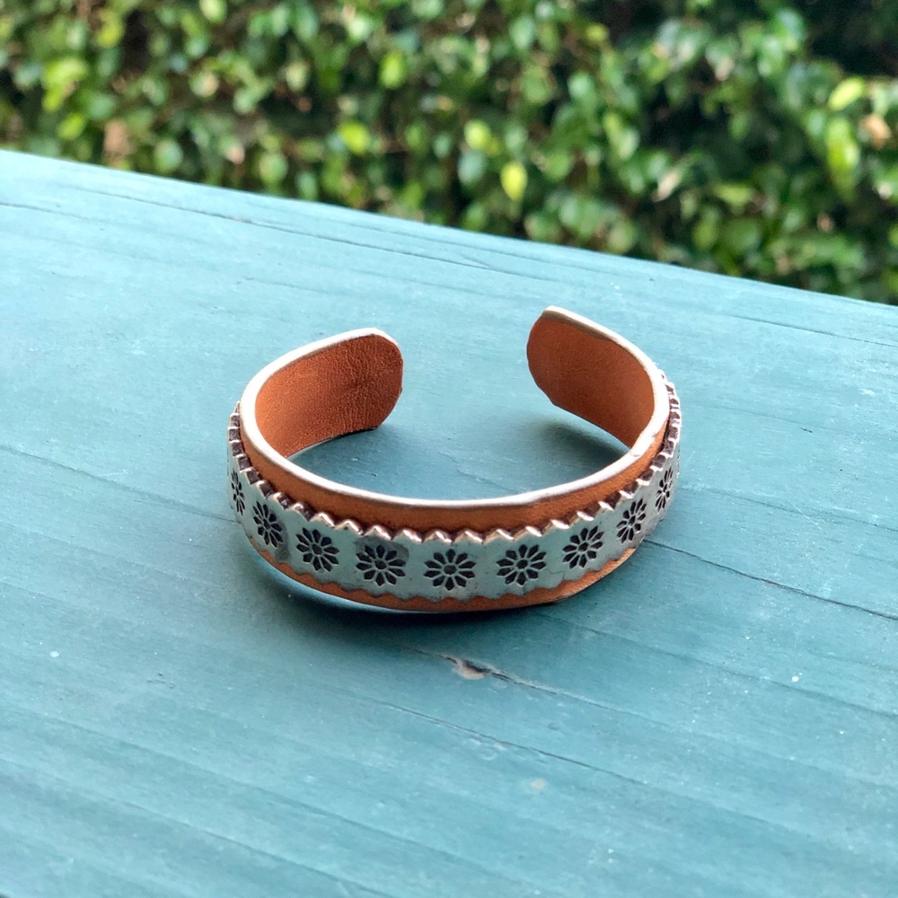 Silver Flowered Bracelet atop Leather Backing